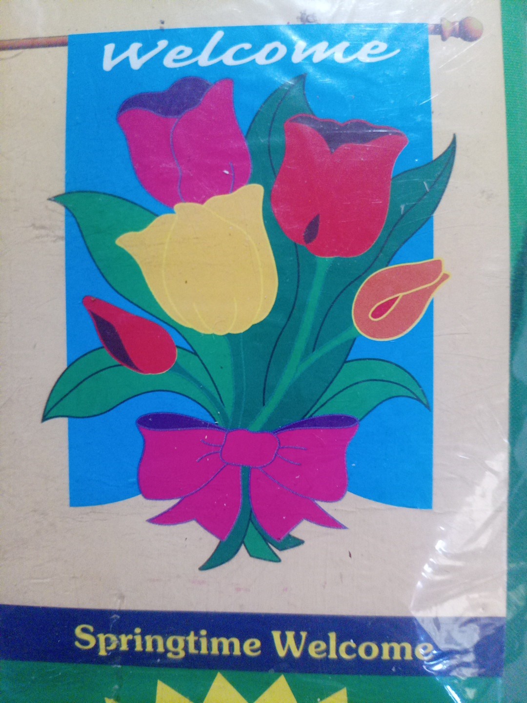 Pink yellow, red,and orange Tulip with green leaves in a bow(Welcome Flag) no po