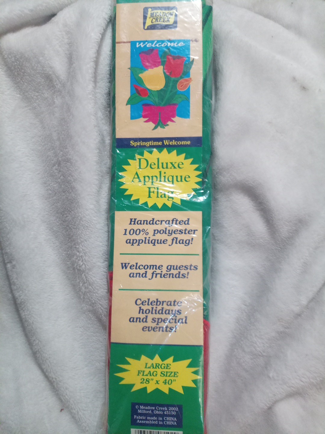 Pink yellow, red,and orange Tulip with green leaves in a bow(Welcome Flag) no po